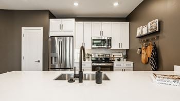 Kitchen with white cabinetry and appliances
